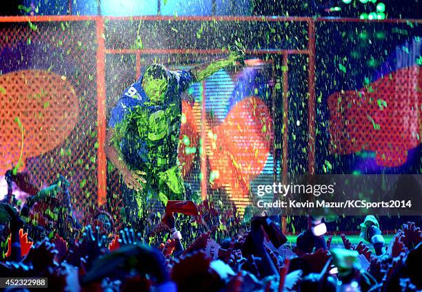 Host Michael Strahan gets slimed onstage at the Nickelodeon Kids' Choice Sports Awards 2014 at UCLA's Pauley Pavilion on July 17, 2014 in Los...
