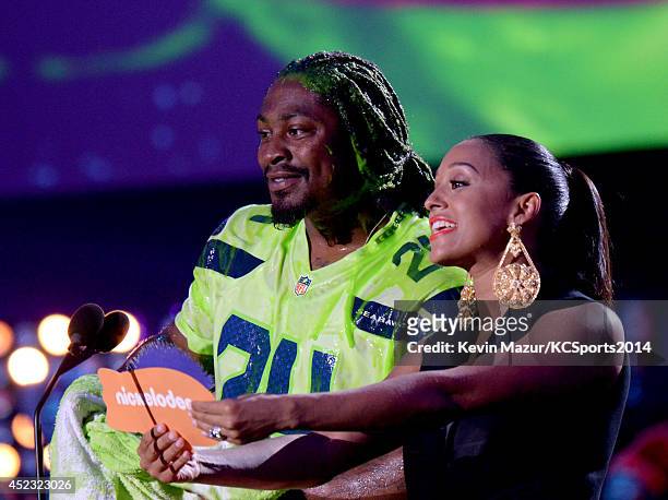Player Marshawn Lynch and actress Tia Mowry-Hardrict speak onstage during the Nickelodeon Kids' Choice Sports Awards 2014 at UCLA's Pauley Pavilion...