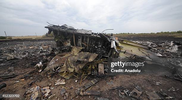 Part of plane is seen amongst the wreckages of a Malaysia Airlines Boeing 777 carrying 295 people from Amsterdam to Kuala Lumpur after it was downed...