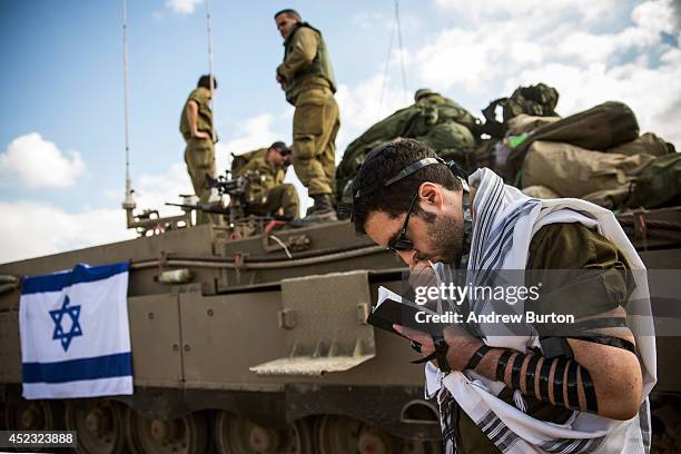 An Israeli reservist troop prays near the Israeli-Gaza border on the morning of July 18, 2014 near Sderot, Israel. Late last night Israeli forces...