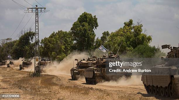 Israeli tanks move positions near the Israeli-Gaza border on the morning of July 18, 2014 near Sderot, Israel. Late last night Israeli forces...