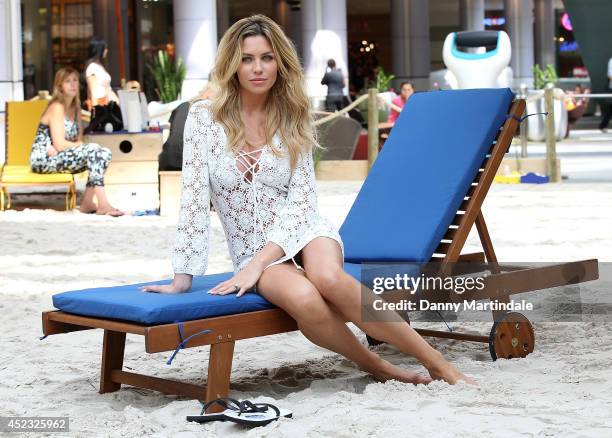 Abbey Clancy attends a photocall to launch the Scholl Pop Up Pedicure Beach at Westfield on July 18, 2014 in London, England.