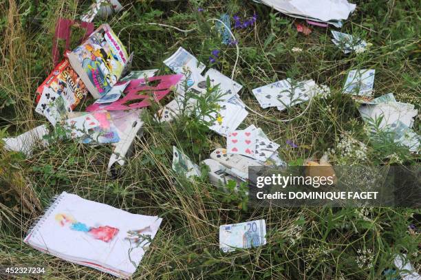 Picture taken on July 18, 2014 shows belongings of passengers on the site of the crash of the Malaysia Airlines jet carrying 298 people from...