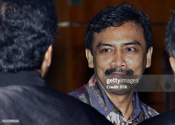 Indonesia's former sports minister Andi Mallarangeng greets his counsel following a guilty verdict by an anti-corruption court in Jakarta on July 18,...