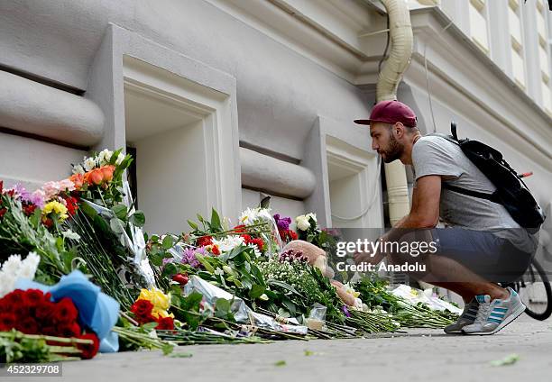 Russian and Dutch citizens light candles and lay flowers in front of the Embassy of the Netherlands for passengers, died in the crash of Malaysia...