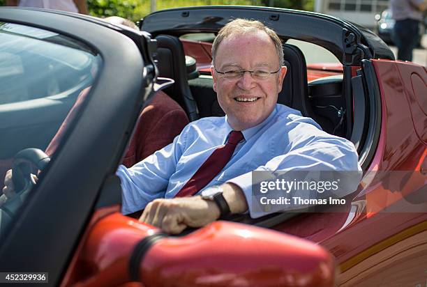 Stephan Weil, Prime Minister of German State Lower-Saxony, drives a Tesla Roadster electric vehicle during his visit to Energy Research Center Lower...