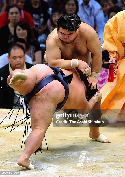 Takayasu throws Toyonoshima to win during day six of the Grand Sumo Nagoya Tournament at Aichi Prefecture Gymnasium on July 18, 2014 in Nagoya,...