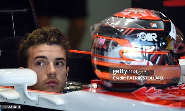 Marussia's French driver Jules Bianchi reacts in the pits during the first practice session ahead of the German Formula One Grand Prix at the...