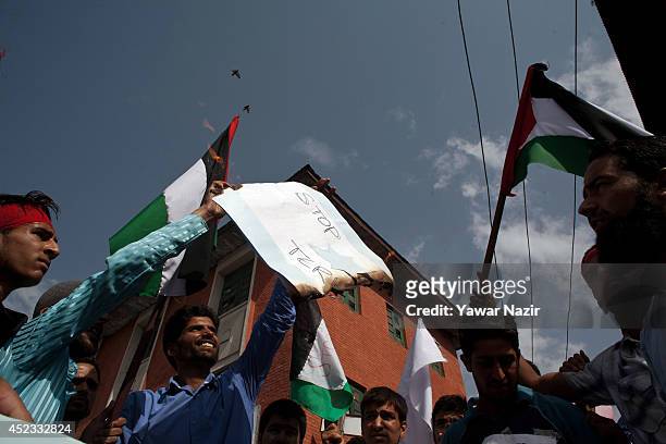Kashmiri Muslim protesters set ablaze an Israeli flag during a protest against Israel's military operation in Gaza on July 18 in Srinagar, the summer...