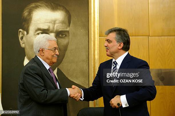 Turkish President Abdullah Gul shake hands with Palestinian president Mahmud Abbas during a press conference at Ataturk International Airport on July...