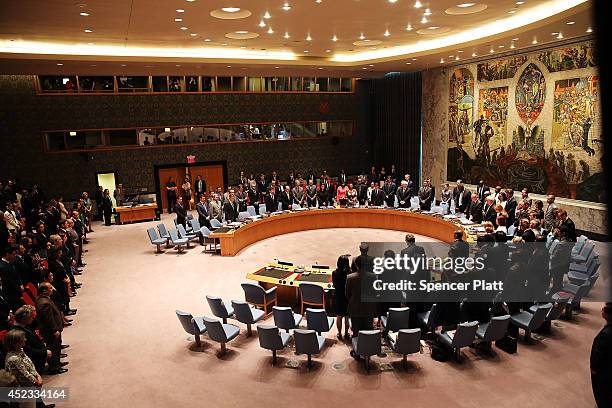 Members of the United Nations Security Council pause during a moment of silence for victims of the downed Malaysia Airlines passenger jet during an...