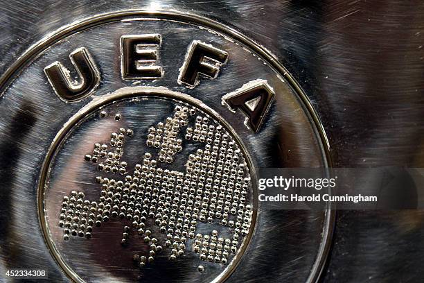 The UEFA logo is seen on the UEFA Champions League trophy as it is prepared for the UEFA 2014/15 Champions League third qualifying rounds draw at the...