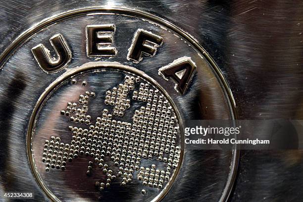 The UEFA logo is seen on the UEFA Champions League trophy as it is prepared for the UEFA 2014/15 Champions League third qualifying rounds draw at the...