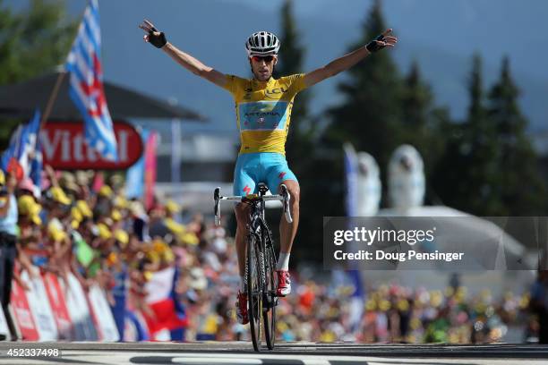 Vincenzo Nibali of Italy and the Astana Pro Team defends the overall race leader's yellow jersey and celebrates as he wins the thirteenth stage of...