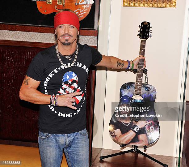 Singer/TV personality Bret Michaels poses for a photo with the guitar he donated to Hard Rock Cafe at Hard Rock Cafe New York on July 18, 2014 in New...