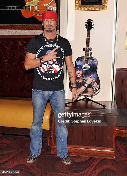 Singer/TV personality Bret Michaels poses for a photo with the guitar he donated to Hard Rock Cafe at Hard Rock Cafe New York on July 18, 2014 in New...