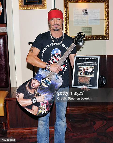 Singer/TV personality Bret Michaels poses for a photo with the guitar he donated to Hard Rock Cafe at Hard Rock Cafe New York on July 18, 2014 in New...