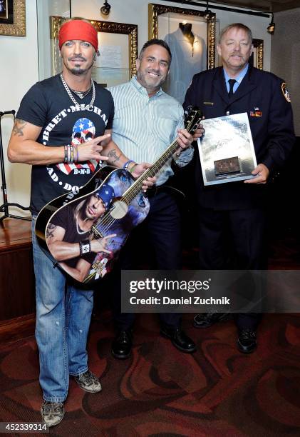 Musician Bret Michaels, Daniel Sarroino and Ray Pfeifer attend the Bret Michaels guitar donation at Hard Rock Cafe New York on July 18, 2014 in New...