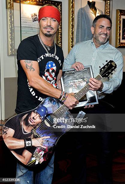 Musician Bret Michaels and Daniel Sarroino attend the Bret Michaels guitar donation at Hard Rock Cafe New York on July 18, 2014 in New York City.
