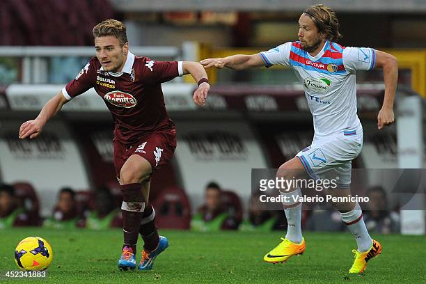 Ciro Immobile of Torino FC in action against Jaroslav Plasil of Calcio Catania during the Serie A match between Torino FC and Calcio Catania at...