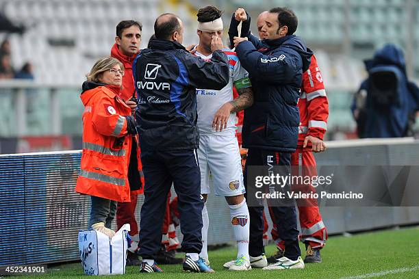 Pablo Alvarez of Calcio Catania receives treatment during the Serie A match between Torino FC and Calcio Catania at Stadio Olimpico di Torino on...