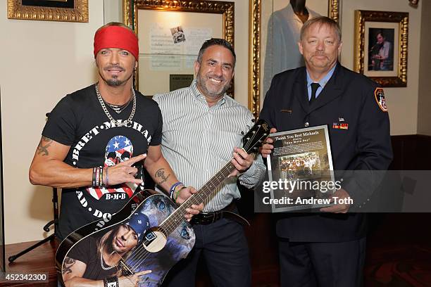 Musician Bret Michaels, FDNY Firefighter Ray Pfeifer and GM of Hard Rock Cafe NYC Daniel Sarroino attend the Bret Michaels guitar donation at Hard...