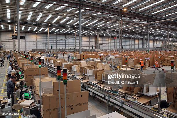 Employees select and dispatch items in the huge Amazon 'fulfilment centre' warehouse on November 28, 2013 in Peterborough, England. The online...