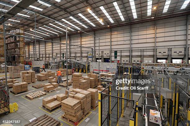 Employees select and dispatch items in the huge Amazon 'fulfilment centre' warehouse on November 28, 2013 in Peterborough, England. The online...