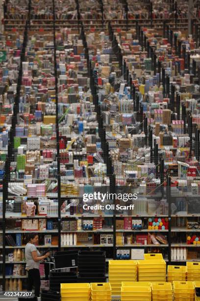 Employees select and dispatch items in the huge Amazon 'fulfilment centre' warehouse on November 28, 2013 in Peterborough, England. The online...