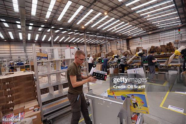 Employees select and dispatch items in the huge Amazon 'fulfilment centre' warehouse on November 28, 2013 in Peterborough, England. The online...