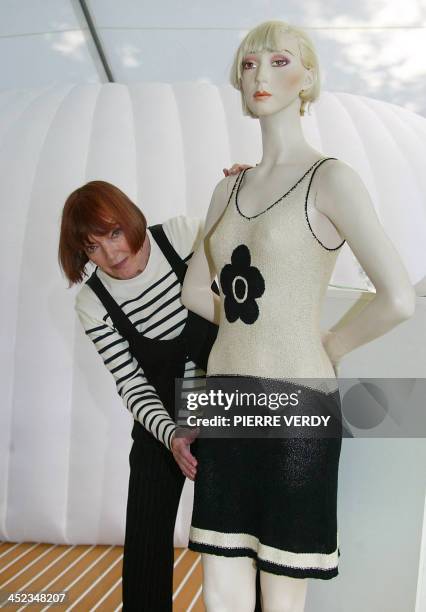 British stylist Mary Quant shows a model wearing one of her clothes, 17 June 2004 in Paris. - Quant introduced both the mini skirt and tights, which...