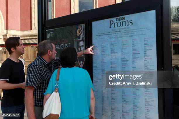 People look at a sign advertising the schedule for The BBC Proms before the First Night of The Proms at Royal Albert Hall on July 18, 2014 in London,...