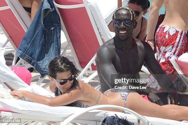 Bacary Sagna and Ludivine Kadri Sagna are sighted on Miami Beach at the W Hotel. On July 18, 2014 in Miami, Florida.