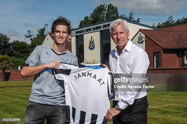 Manager Alan Pardew poses for photographs holding a newcastle shirt with new signing Daryl Janmaat at the Newcastle United Training Centre on July...