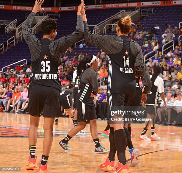 Angel McCoughtry and Erika de Souza of the Eastern Conference high five each other during All-Star Practice and Media Availability on July 18, 2014...