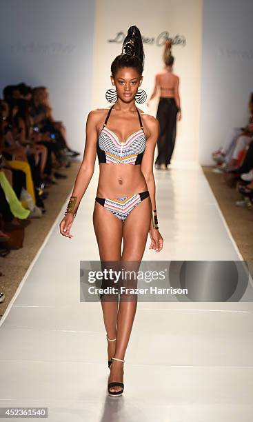 Model walks the runway at the Dolores Cortes fashion show during Mercedes-Benz Fashion Week Swim 2015 at The Raleigh on July 18, 2014 in Miami Beach,...