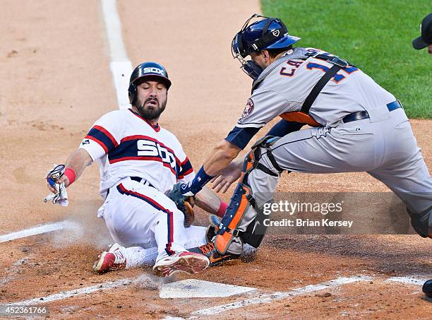 Catcher Jason Castro of the Houston Astros tags out Adam Eaton of the Chicago White Sox as Eaton tried to tag up and score from third base on a fly...