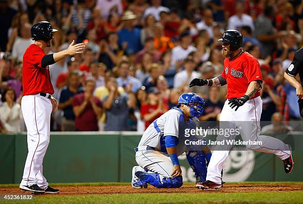 Jonny Gomes of the Boston Red Sox celebrates with teammate Stephen Drew after hitting the go-ahead two-run home run in the sixth inning against the...