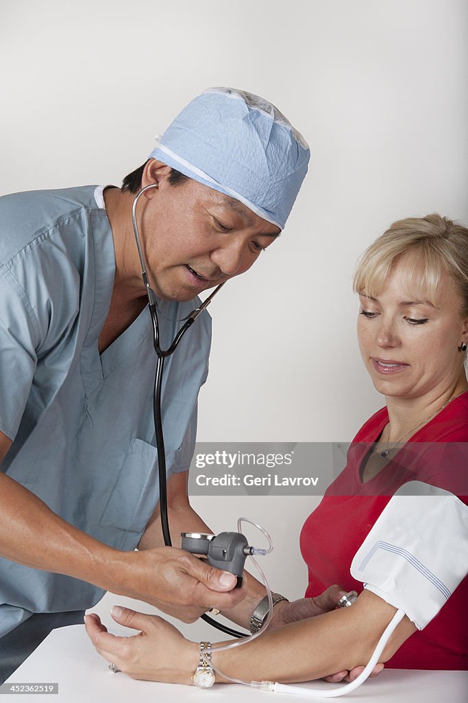 Doctor taking the blood pressure of a patient