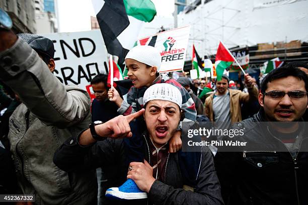 Protestors march from Aotea Square down Queen Street protesting the Israeli ground invasion of Gaza on July 19, 2014 in Auckland, New Zealand. The...