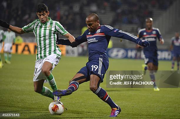 Lyon's French forward Jimmy Briand vies with Seville's Spanish defender Juanfran during the Europa League football match Olympique Lyonnais vs Real...