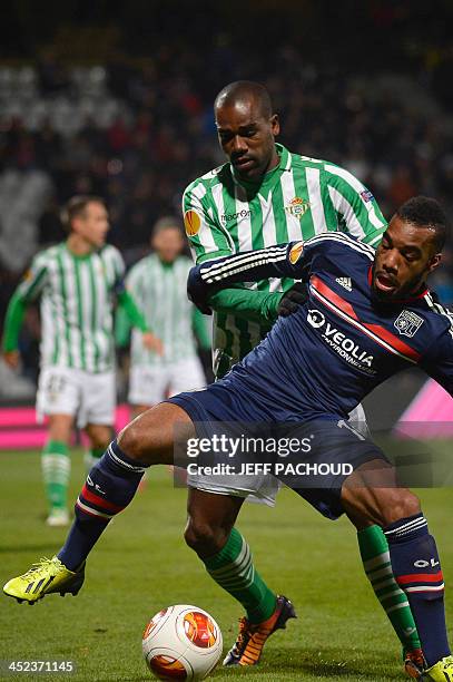 Seville's Brazilian defender Paulao vies with Lyon's French forward Alexandre Lacazette during the Europa League football match Olympique Lyonnais vs...