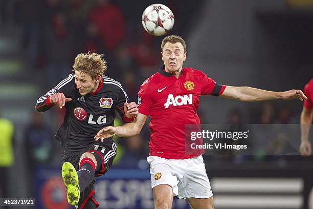 Simon Rolfes of Bayer Leverkusen, Jonny Evans of Manchester United during the Champions League match between Bayer Leverkusen and Manchester United...