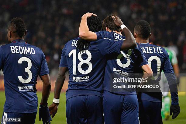 Lyon's French forward Bafetimbi Gomis celebrates with Lyon's French midfielder Yoann Gourcuff after scoring a goal during the UEFA Europa League...
