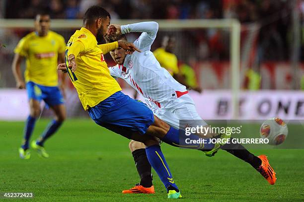 Estoril's Brazilian midfielder Joao Pedro Galvao vies with Sevilla's defender Alberto Moreno during the UEFA Europa League football match Sevilla FC...