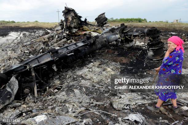 Local resident stands among the wreckage at the site of the crash of a Malaysia Airlines plane carrying 298 people from Amsterdam to Kuala Lumpur in...