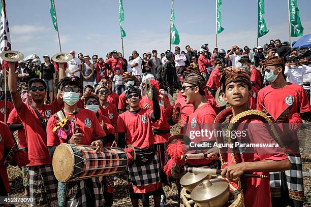 Participants play traditional gamelan orchestra instruments during the Bali Kite Festival on July 19, 2014 in Denpasar, Bali, Indonesia. The event is...