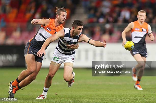 Shane Kersten of the Cats competes for the ball against Tim Mohr of the Giants during the round 18 AFL match between the Greater Western Sydney...