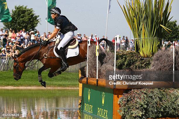 Lucy Jackson of New Zealand rides on Willy Do and falls down during the DHL Price Cross Country Test at Aachener Soers on July 19, 2014 in Aachen,...
