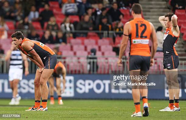 Giants players Tom Boyd, Jonathon Patton and Jeremy Cameron look dejected after defeat in the round 18 AFL match between the Greater Western Sydney...